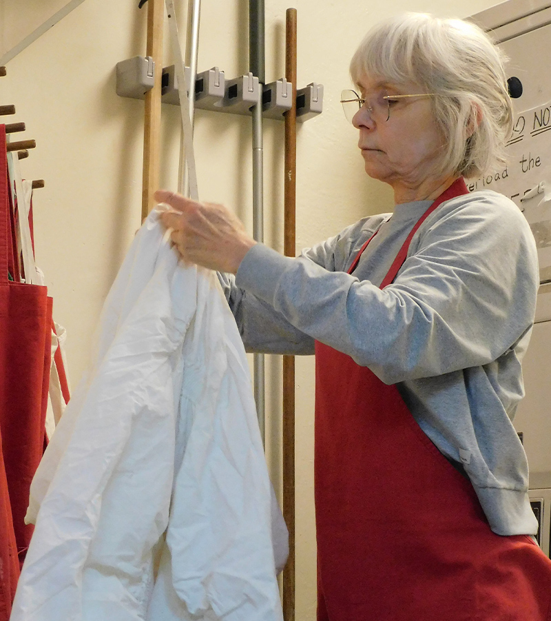 Volunteer folding clothes in the shelter